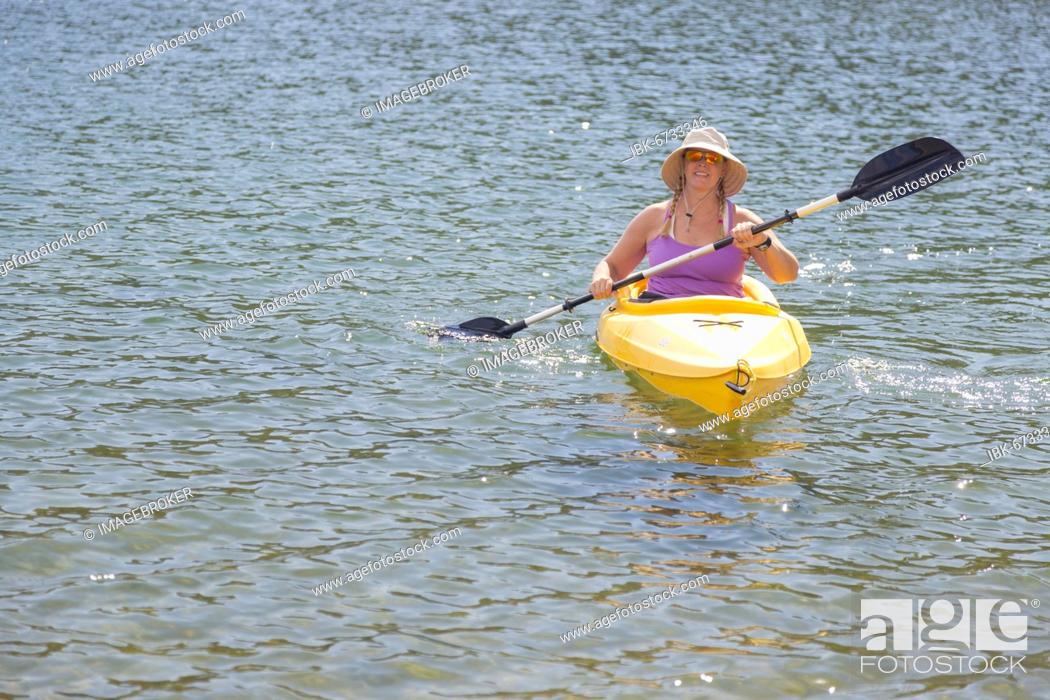 Photo de stock: Woman kayaking on beautiful peaceful mountain lake.