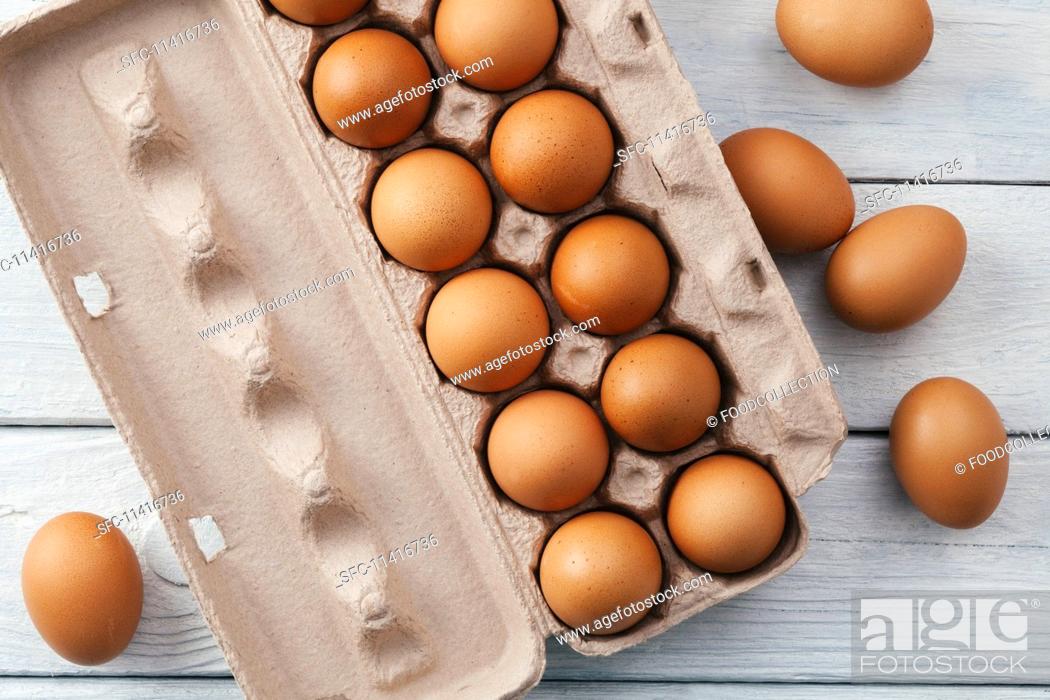 Stock Photo: Brown eggs in egg box.