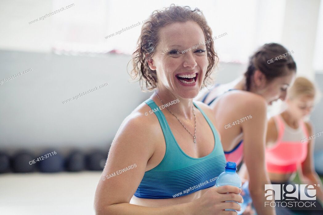 Stock Photo: Portrait smiling, laughing woman drinking water and resting post workout at gym.