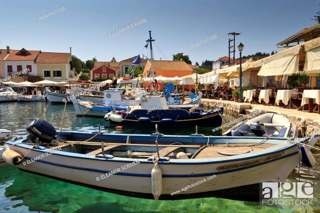 Stock Photo: Harbourside with boats, cafes and clear green water, Fiskardo, Kefalonia (Cephalonia), Ionian Islands, Greece.