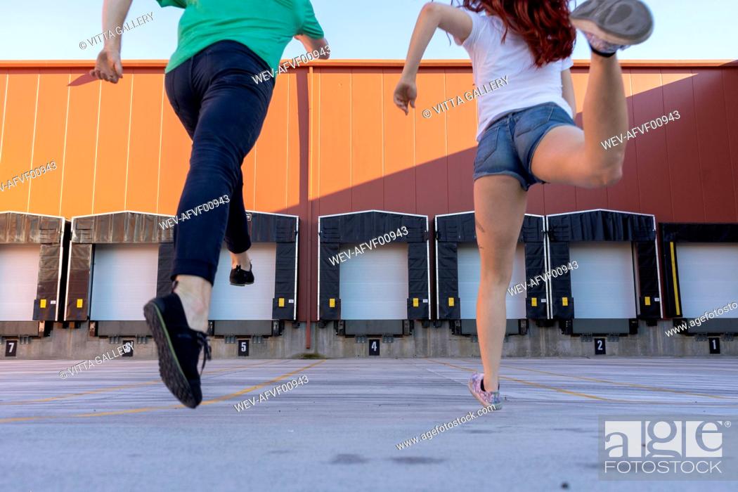Stock Photo: Two acrobats running during training, rear view.