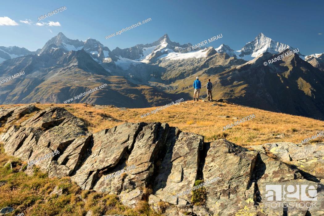 Stock Photo: two hikers, Ober Gabelhorn, Zinalrothorn, Weisshorn, Zermatt (village), Valais, Switzerland.