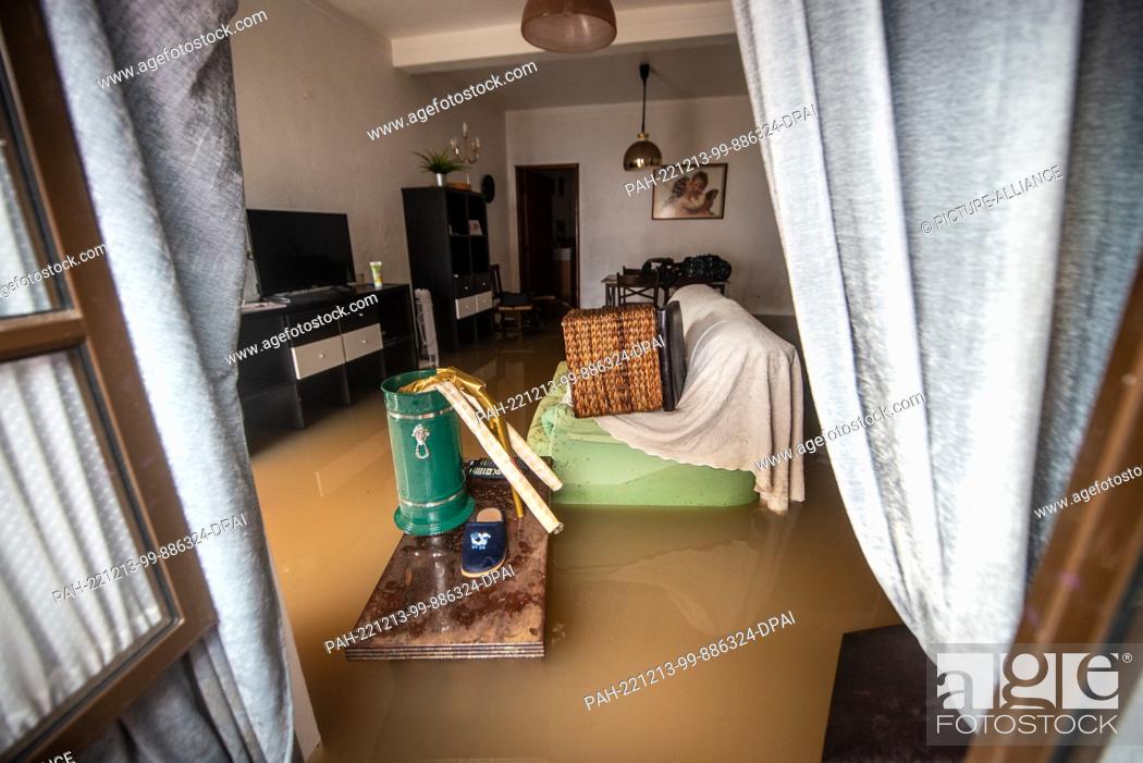 Stock Photo: 13 December 2022, Portugal, Lissabon: View into the living room of a flooded house. Heavy rains have caused damage to streets.