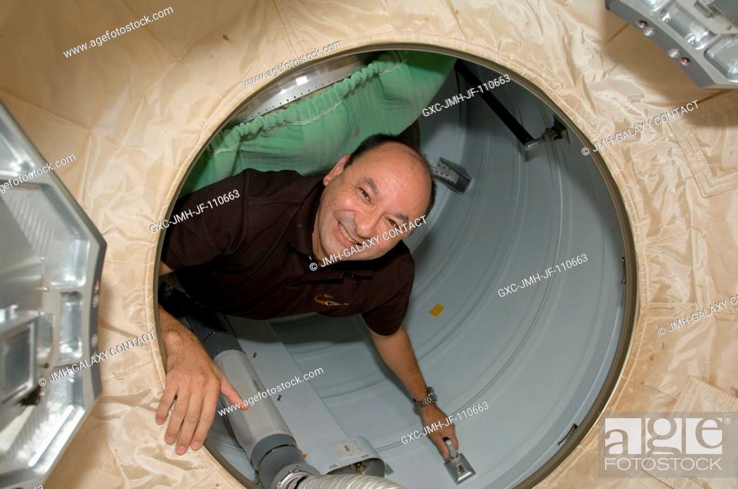 Stock Photo: NASA astronaut Mark Polansky, STS-127 commander, is pictured in the hatch between Space Shuttle Endeavour and the International Space Station as the STS-127.