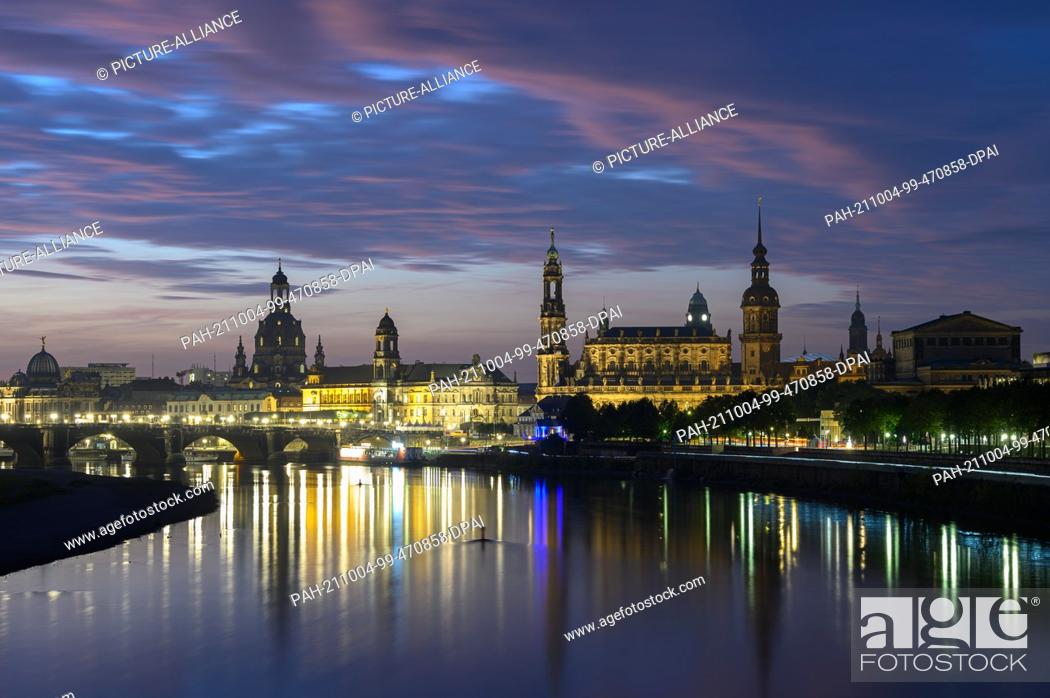 Stock Photo: 04 October 2021, Saxony, Dresden: Panoramic view in the morning onto the historical Old Town at the river Elbe with the dome of the Academy of Arts (l-r).