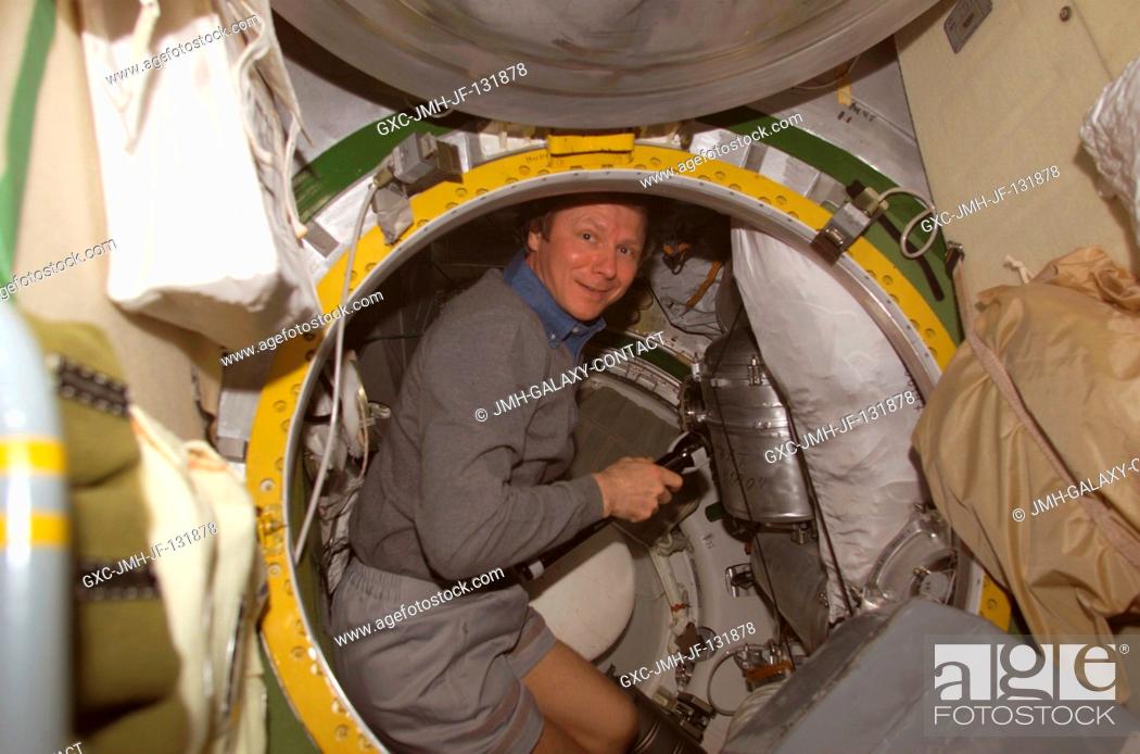 Stock Photo: Cosmonaut Gennady I. Padalka, Expedition 9 commander representing Russia's Federal Space Agency, performs an interface leak check in the Pirs Docking.