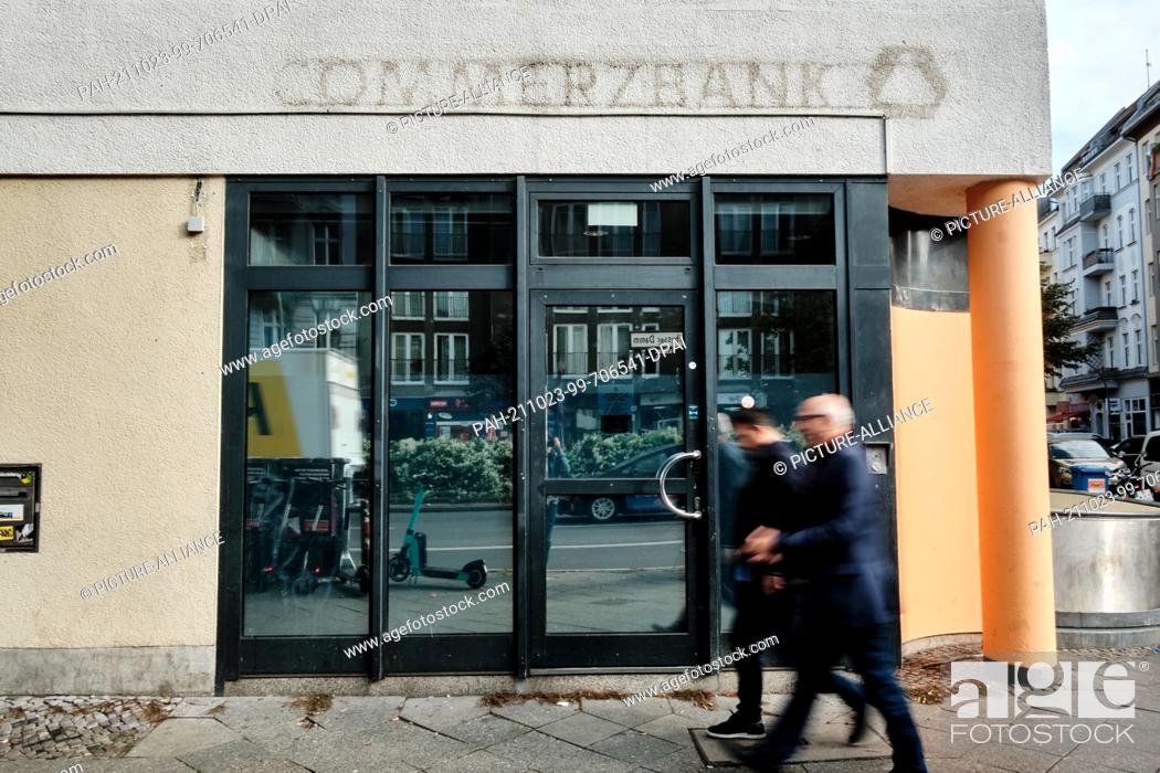 Stock Photo: 18 October 2021, Berlin: The faded lettering of Commerzbank and its logo, can be seen above a recently closed Commerzbank branch on a building facade on.