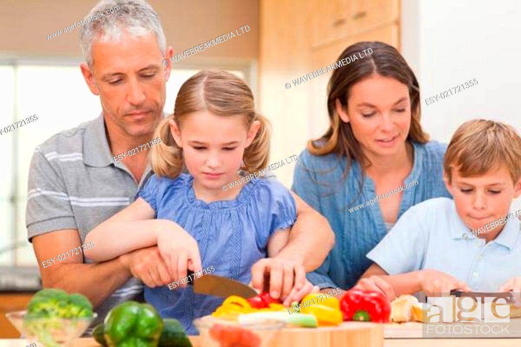 Photo de stock: Charming family cooking together.