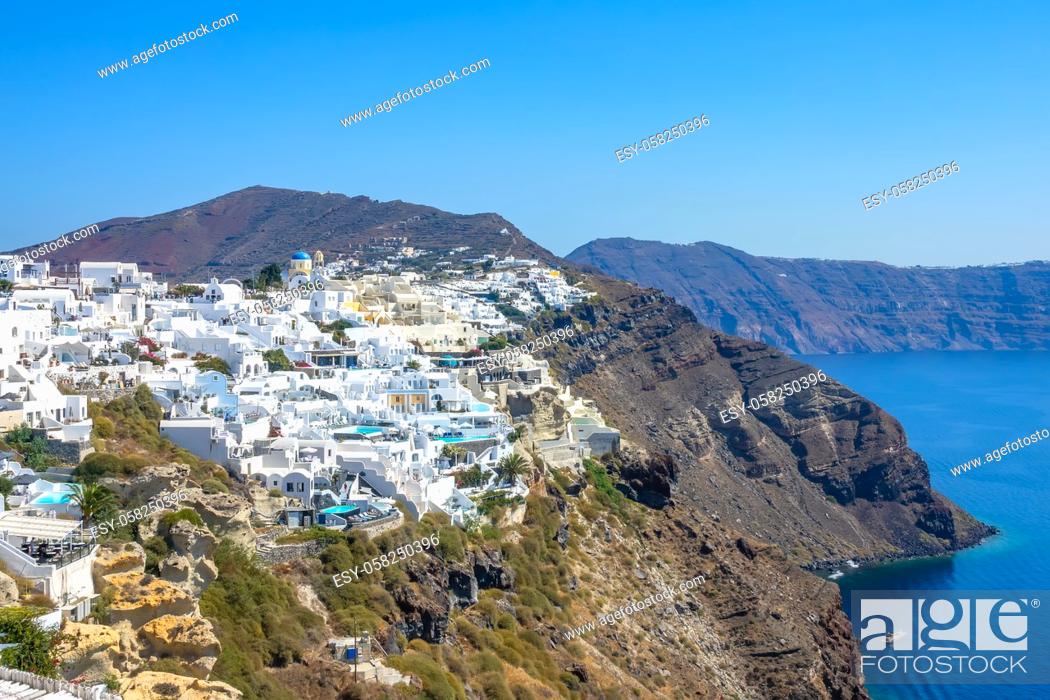 Stock Photo: Greece. Colorful buildings on the Santorini caldera. Sunny summer day over the rocky coast.