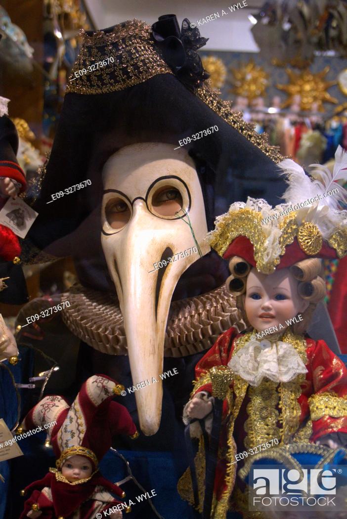 Stock Photo: "Medico della peste" - Plague Doctor - Carnevale mask in shop window along with dolls, Venice, Italy.