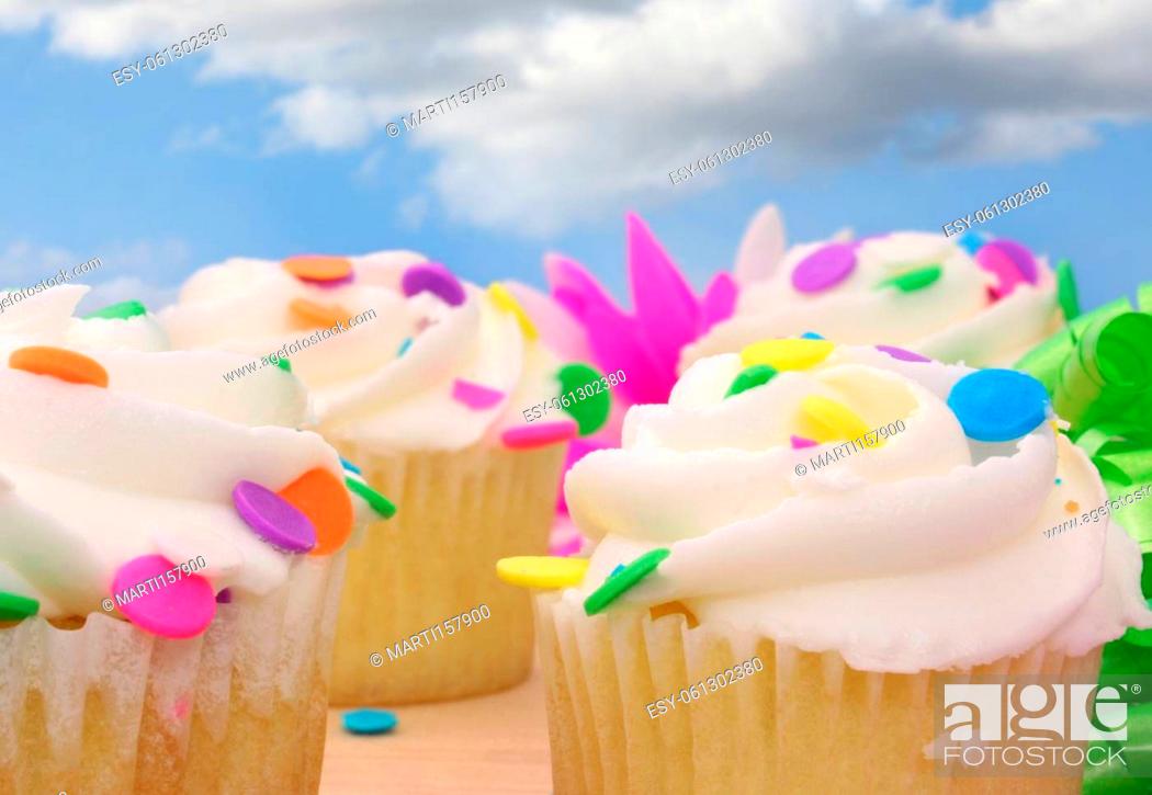 Stock Photo: Cupcakes and Flower with Beads and Ribbon on Wooden Table.