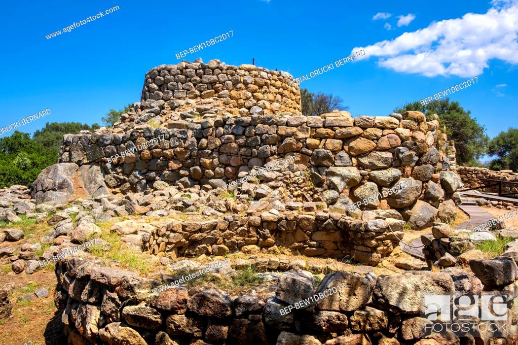 Stock Photo: Arzachena, Sardinia / Italy - 2019/07/19: Archeological ruins of Nuragic complex La Prisgiona - Nuraghe La Prisgiona - with stone main tower and preserved.