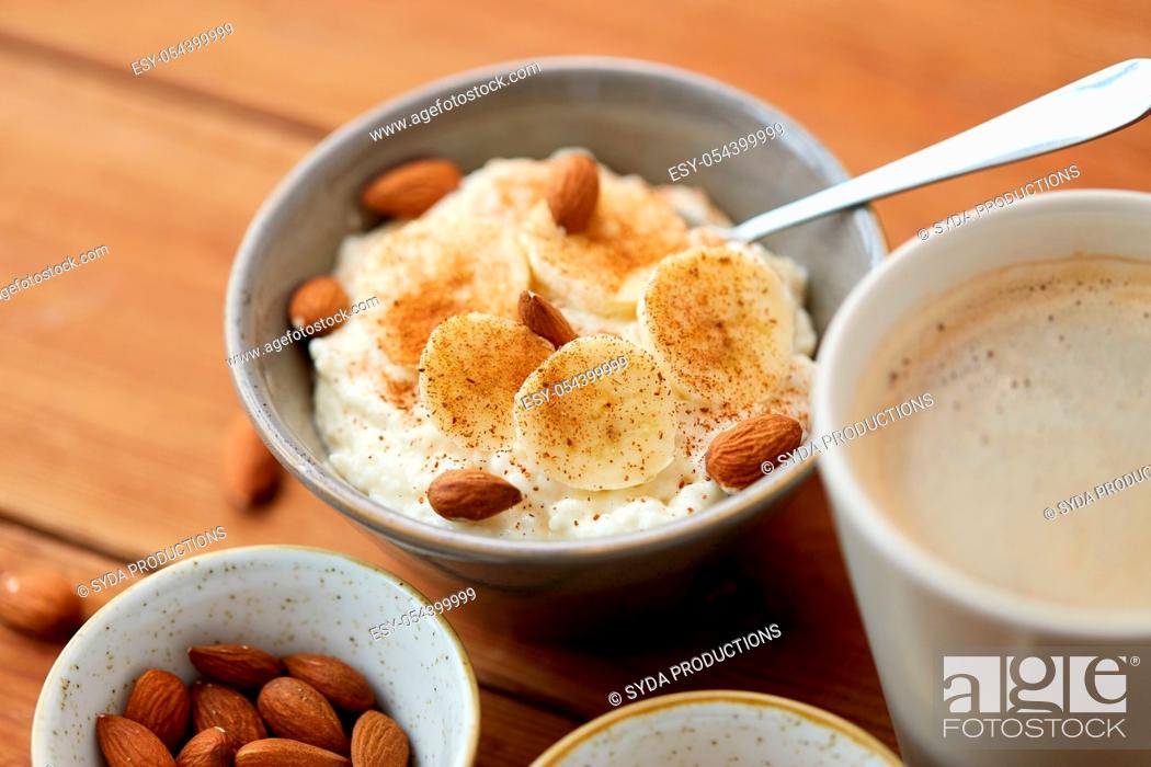 Stock Photo: oatmeal with banana and almond on wooden table.