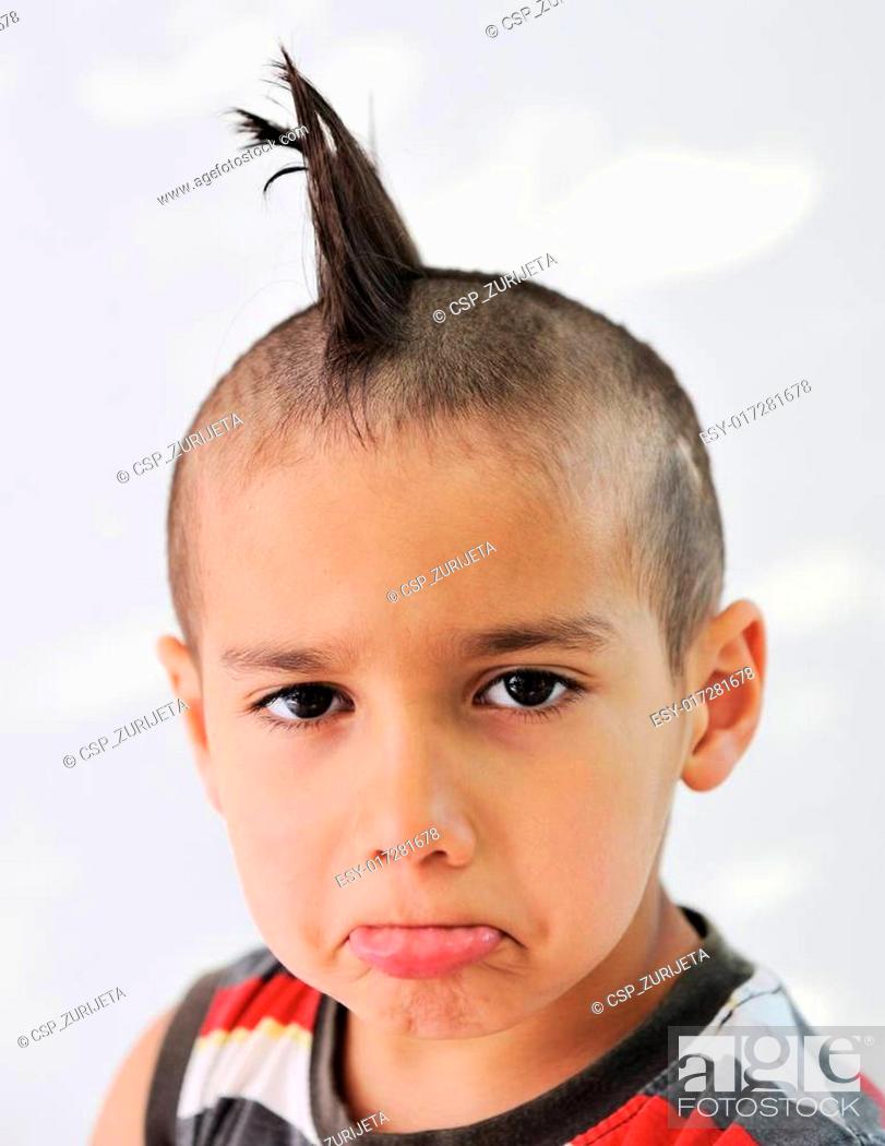 Cute little boy with funny hair and cheerful grimace, Stock Photo, Picture  And Low Budget Royalty Free Image. Pic. ESY-017281678 | agefotostock