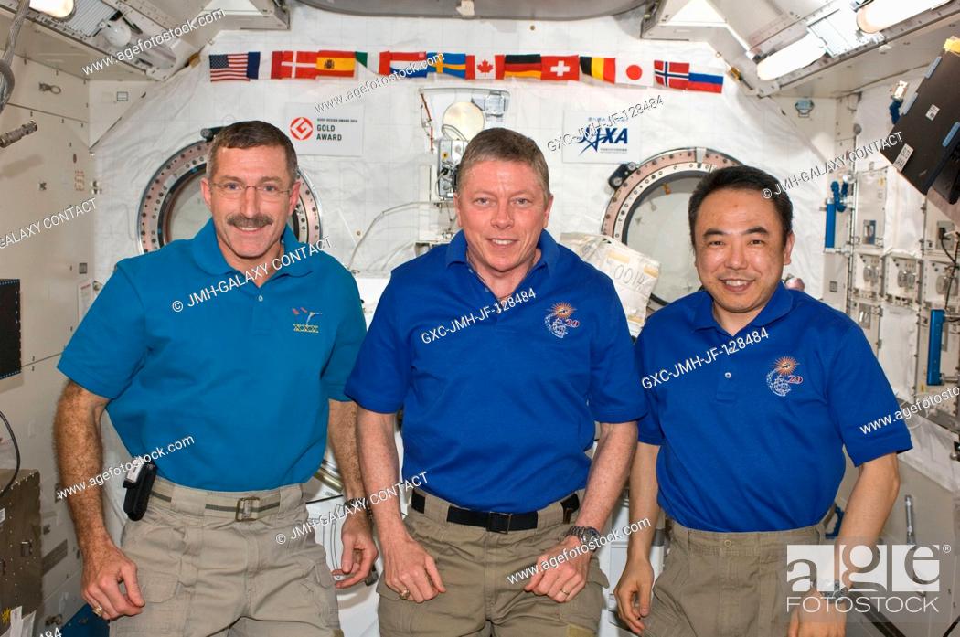 Stock Photo: NASA astronauts Dan Burbank (left), Expedition 30 commander; and Mike Fossum (center), Expedition 29 commander; along with Japan Aerospace Exploration Agency.
