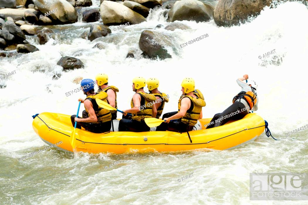 Stock Photo: Group Of Mixed Tourist Men And Women With Guided By Professional Pilot On Whitewater River Rafting In Ecuador.