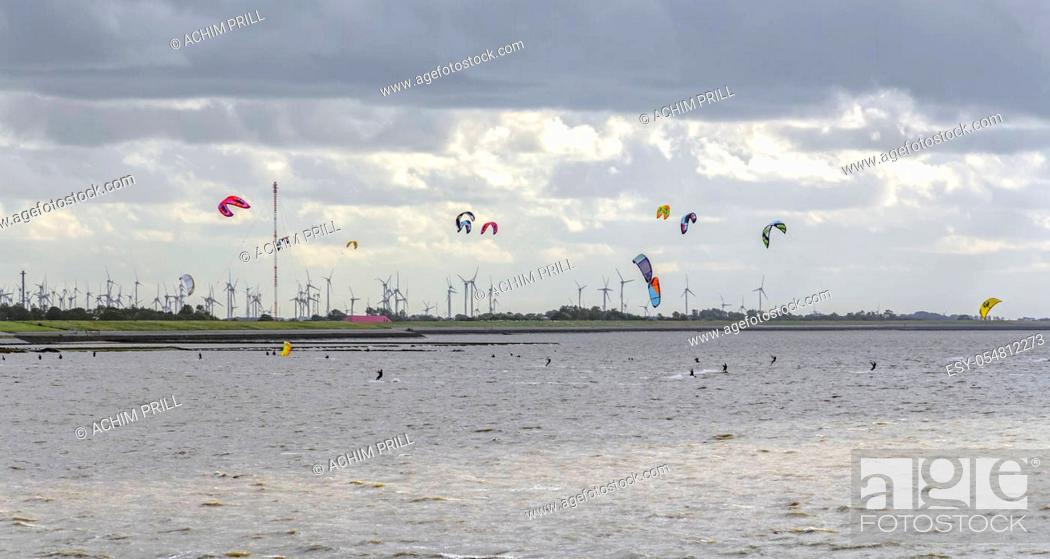 Stock Photo: stormy coastal scenery including some kitesurfers near Neuharlingersiel in Eastern Frisia, Germany.