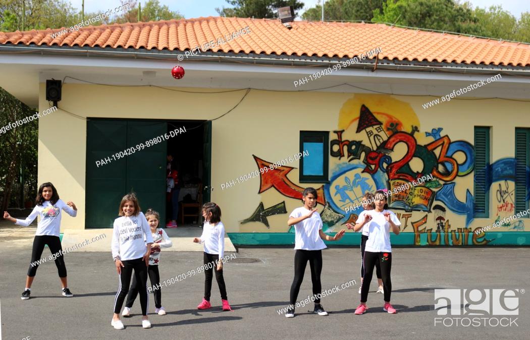 Stock Photo: 17 April 2019, Albania, Tirana: Children dance in the courtyard of the SOS Children's Village in Tirana. The SOS Children's Village in the suburb of Sauk in the.