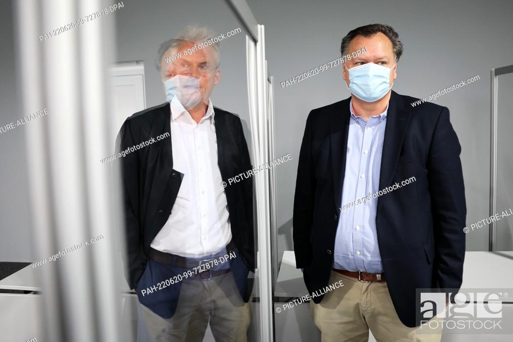 Stock Photo: 20 June 2022, Schleswig-Holstein, Lübeck: The defendant (r) and his lawyer Michael Gubitz talk before the start of the trial day in a branch of the Lübeck.