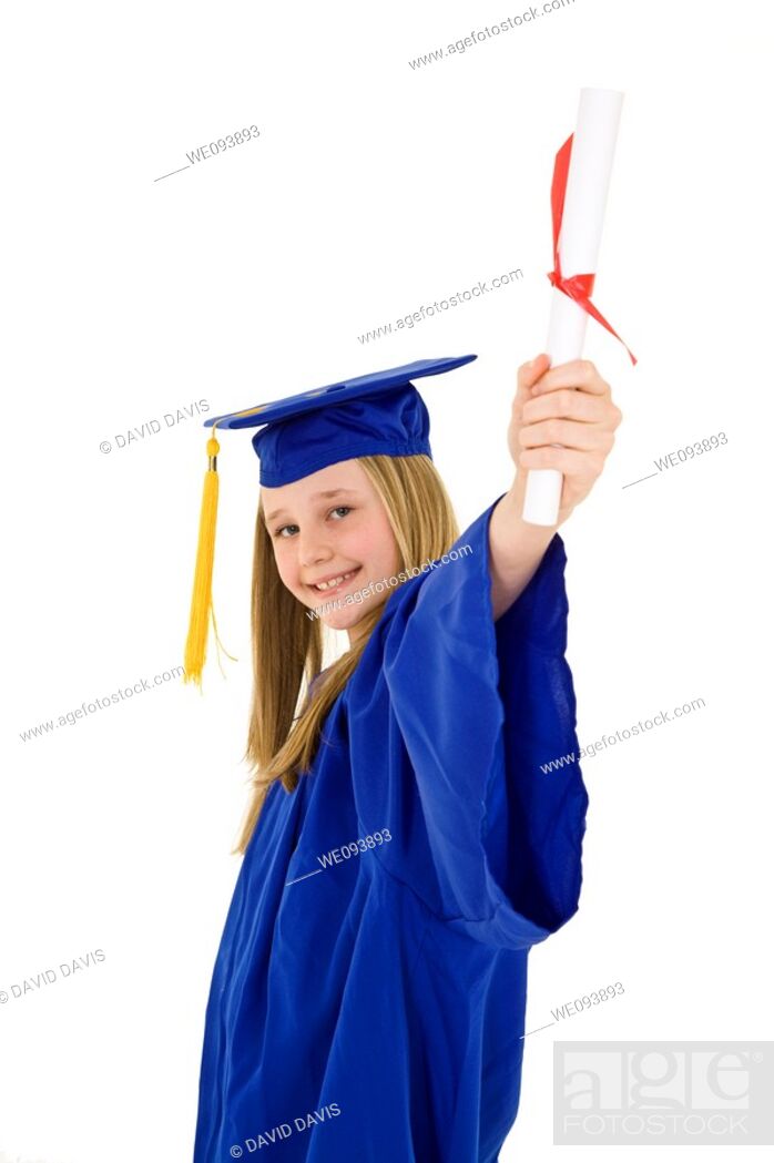 A preteen caucasian girl with blond hair standing in blue graduation gown  and smiling She is on a..., Stock Photo, Picture And Royalty Free Image.  Pic. WE093893 | agefotostock