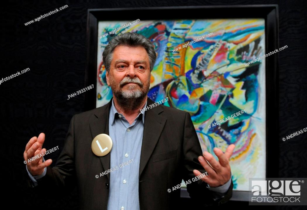 Stock Photo: Museum director Helmut Friedel poses in front of Kandinsky's painting 'Improvisation Klamm' during the re-opening of Lenbachhaus in Munich,  Germany.
