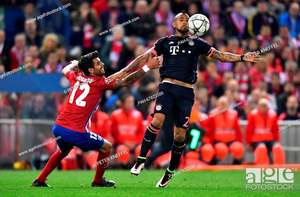 Stock Photo: Munich's Arturo Vidal (R) and Madrid's Augusto Fernandez vie for the ball during the Champions League semi-final match between Atletico Madrid and Bayern Munich.